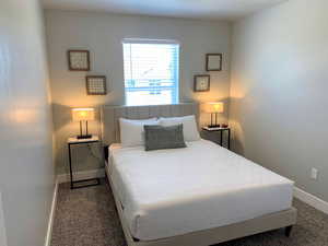 Bedroom with baseboards and carpet