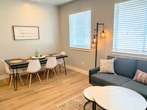 Dining space featuring light wood-style flooring and baseboards
