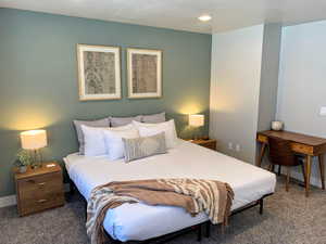 Carpeted bedroom featuring baseboards