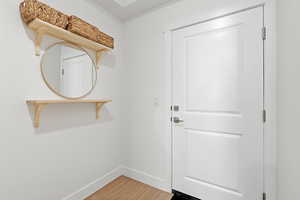 Entryway featuring baseboards and wood finished floors