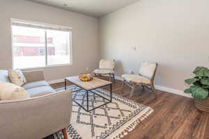 Living area with wood finished floors and baseboards
