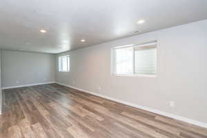 Unfurnished room with dark wood-style flooring and recessed lighting