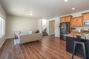 Living room with dark wood-style floors, recessed lighting, and a textured ceiling