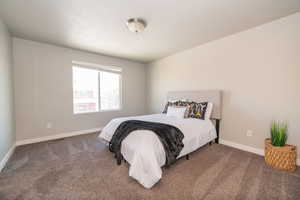 Carpeted bedroom featuring baseboards