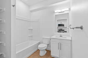 Full bathroom featuring vanity, light wood finished floors, and bathtub / shower combination