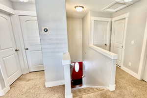 Hall with an upstairs landing and a textured ceiling
