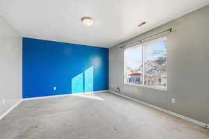 Carpeted bedroom featuring baseboards