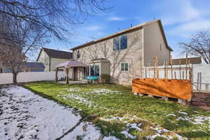 Rear of property with a gazebo, a patio, and a fenced backyard