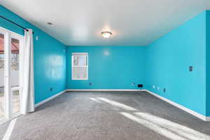 Carpeted empty room with baseboards