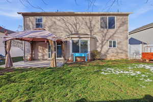 Back of property with a gazebo and a patio area