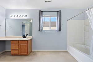 Primary Full bathroom featuring vanity, light carpet, and shower / bath combo