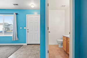 Entryway with baseboards and stone finish flooring