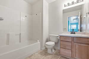 Bathroom with vanity, tub / shower combination, and light tile patterned floors