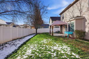 Fenced backyard with a patio area and a gazebo