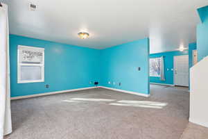 Unfurnished room with light colored carpet and baseboards