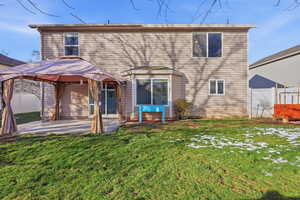 Rear view of house with a gazebo and a patio area