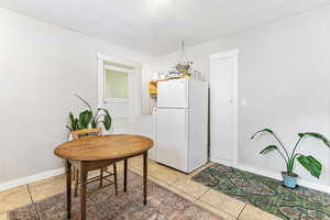 Dining space with washer / clothes dryer, light tile patterned floors, and a textured ceiling