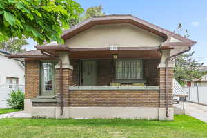 View of front of property featuring brick siding and a porch