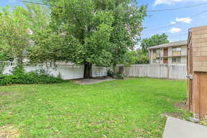 Fenced backyard with a patio