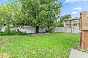 Fenced backyard with a patio