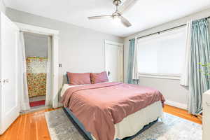 Bedroom with light wood-style floors and ceiling fan