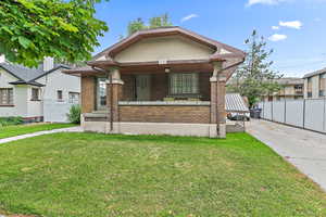 View of front of property featuring covered porch and brick siding