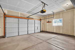 Garage featuring a garage door opener