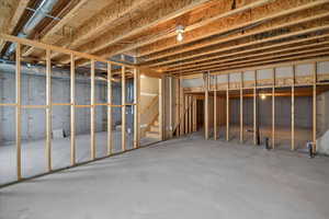 Unfinished basement featuring stairs