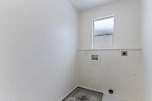 Laundry room with electric dryer hookup, washer hookup, and unfinished concrete flooring
