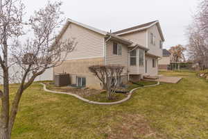 View of side of property featuring a yard and brick siding