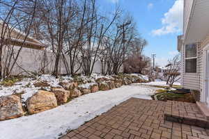 Snow covered patio featuring a patio