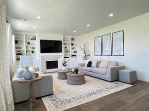 Living area with hardwood / wood-style flooring, a fireplace, and recessed lighting