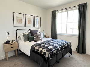 Bedroom with baseboards and light carpet