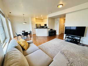 Living room with light wood-style flooring and baseboards