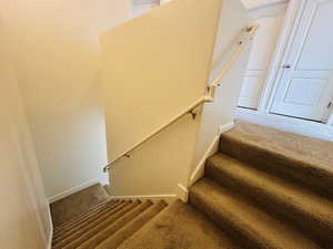 Stairway featuring carpet and baseboards