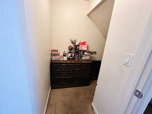 Hallway with baseboards and carpet floors