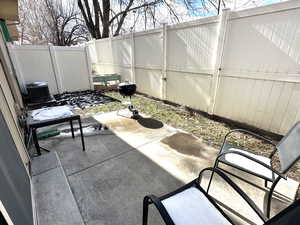 Fenced backyard with a patio and grilling area