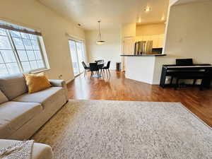 Living room with recessed lighting and light wood-type flooring