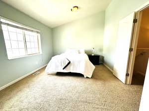 Carpeted bedroom featuring baseboards