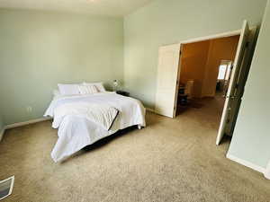 Carpeted bedroom featuring baseboards