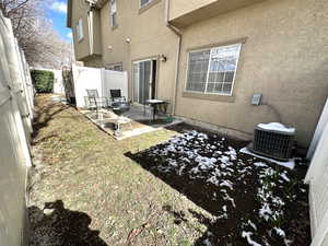 Back of property featuring a fenced backyard, a patio area, and stucco siding