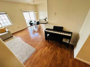 Living area featuring baseboards and wood finished floors