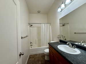 Bathroom featuring vanity and shower / bath combo