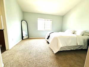 Carpeted bedroom featuring baseboards