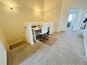 Carpeted office space featuring baseboards