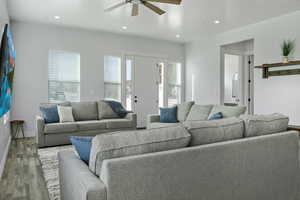 Living area featuring wood finished floors, recessed lighting, and a ceiling fan