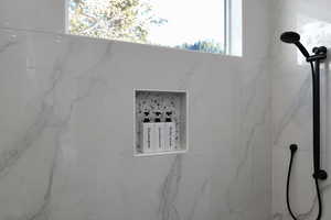 Bathroom view of a marble finish shower