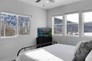 Bedroom with a ceiling fan and baseboards