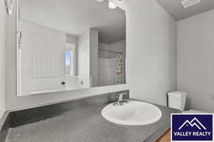 Full bath with vanity and a shower with shower curtain