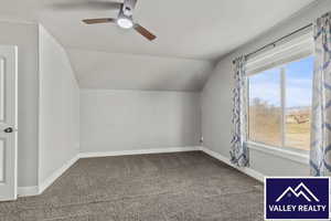 Bonus room with carpet flooring, lofted ceiling, and a ceiling fan